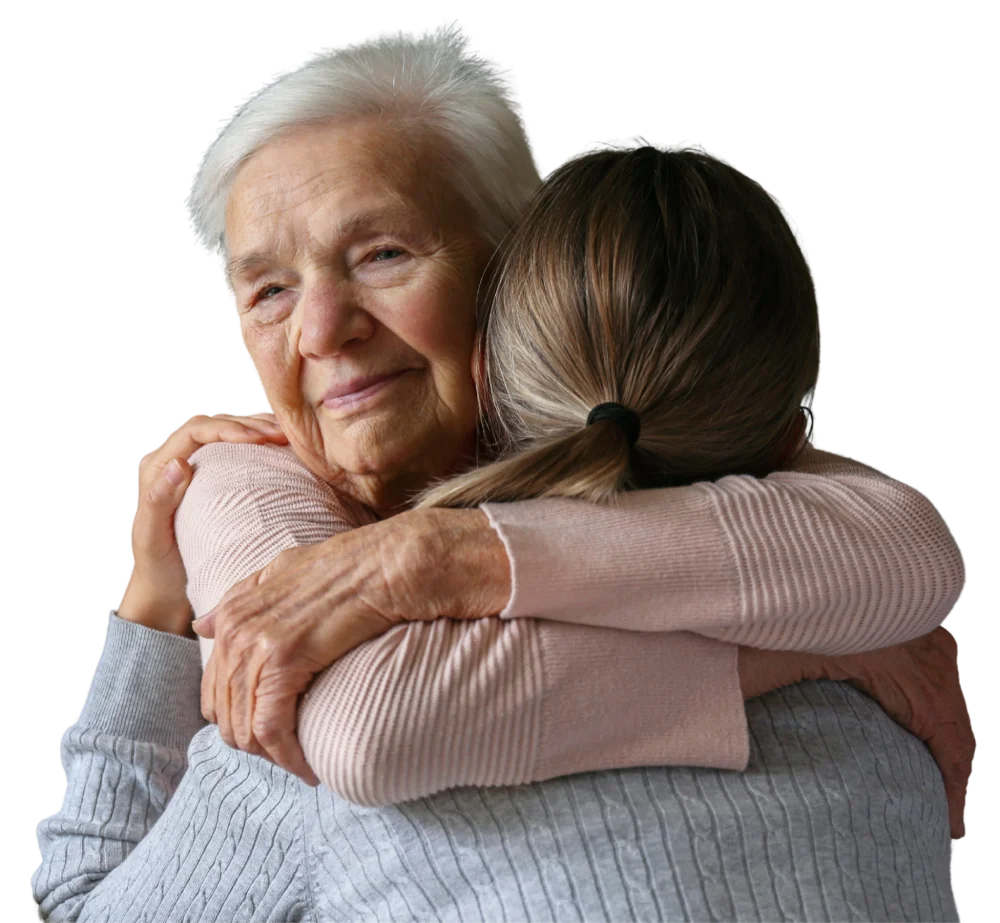Young woman affectionately hugging an elderly woman.